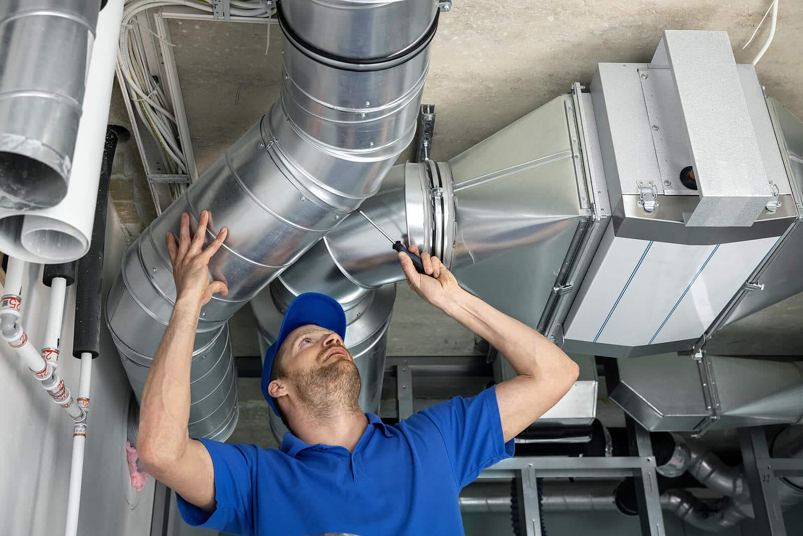 HVAC technician inspecting and repairing air ducts in Petaluma