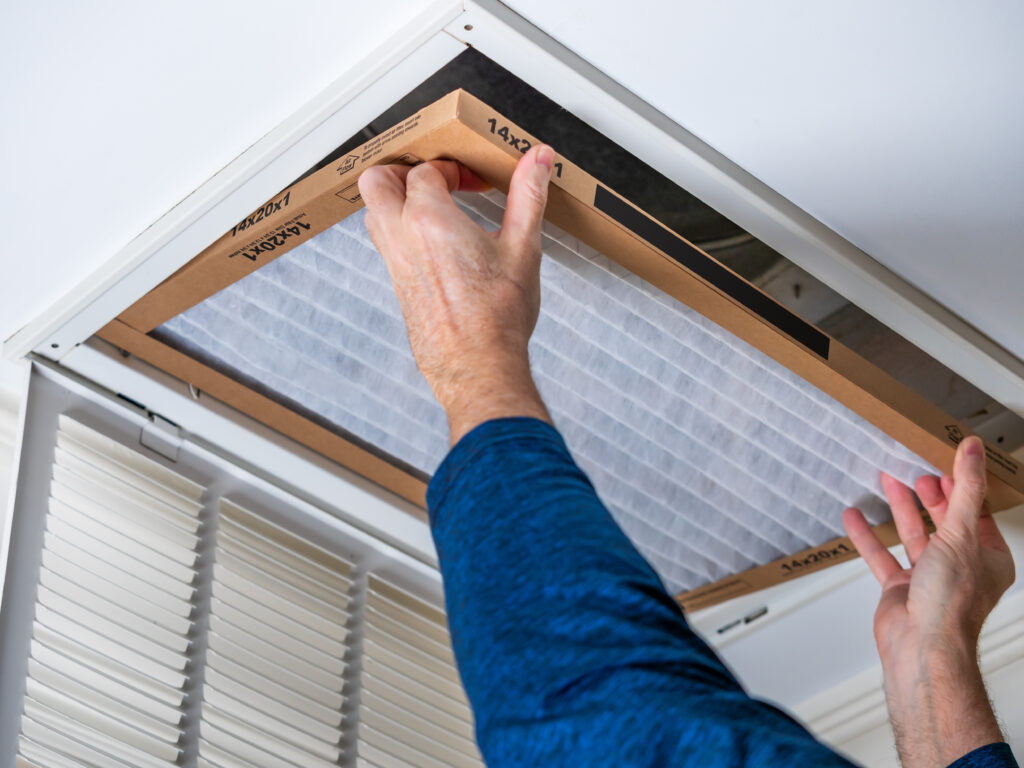 HVAC technician replacing a home air filter in Petaluma