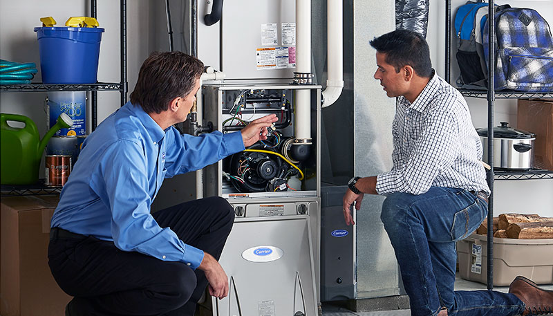 Technician evaluating a furnace for repair or replacement in Petaluma
