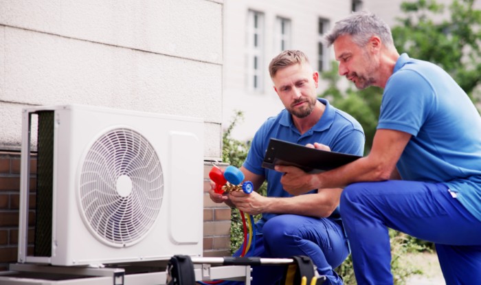 HVAC technicians installing an outdoor air conditioning unit in Petaluma